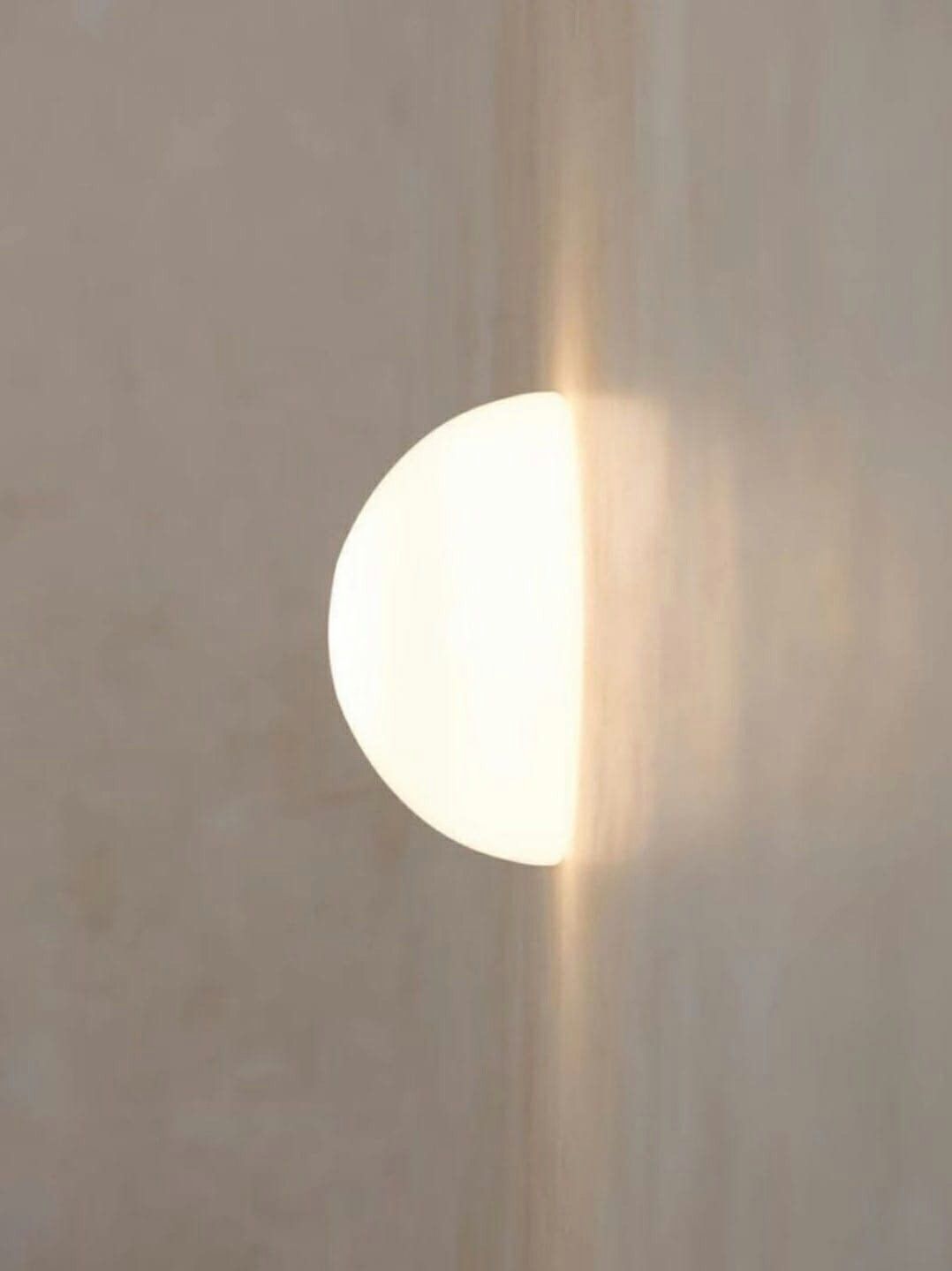 Juego de luz natural creando un círculo radiante en la pared, inspiración para el primer ritual de La Mais OM.